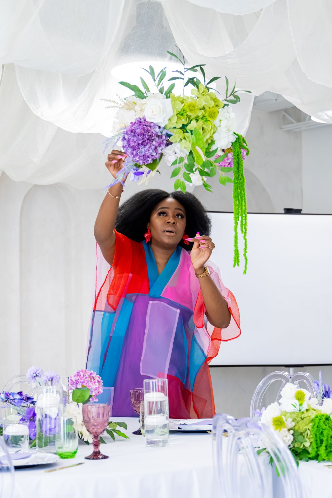Onyeka of Events & Partea placing florals at a styled event